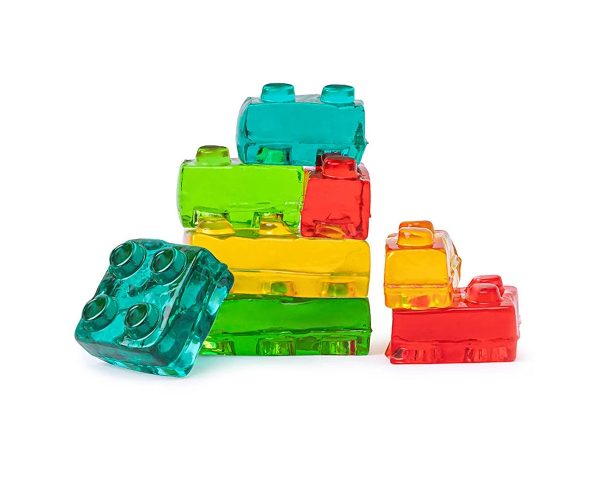 Colorful gummi building blocks stacked on a white background