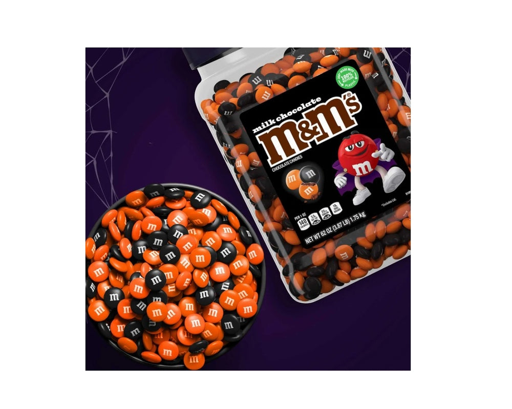 M&M's Halloween-themed packaging with orange and black candies on a purple background
