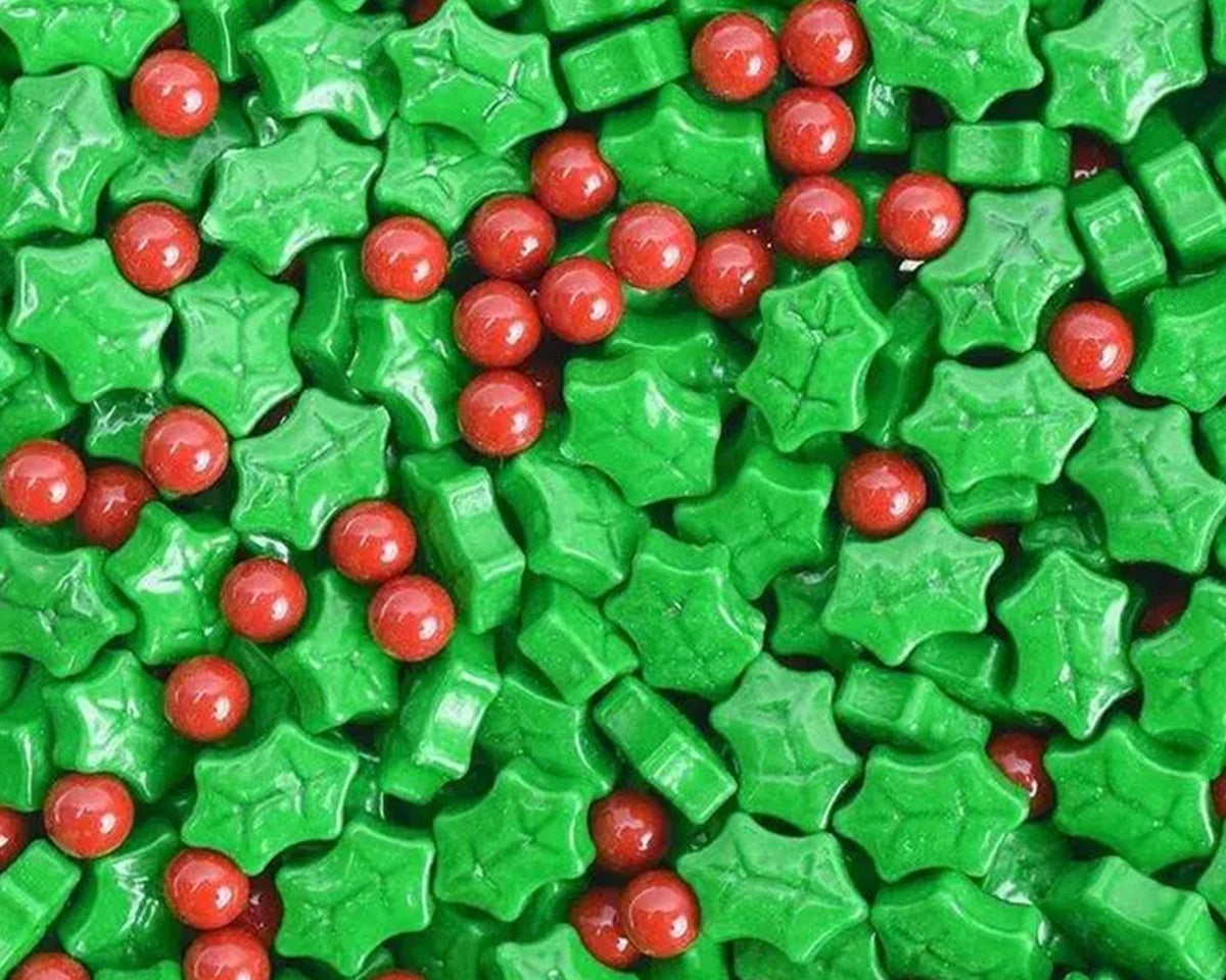 Green holly leaves and red berries candy pieces.